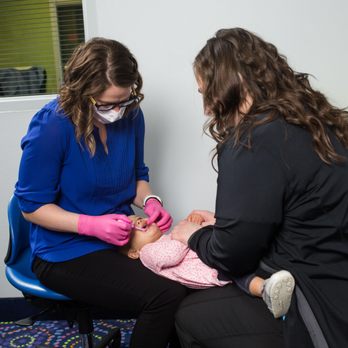 Vaughn Pediatric Dentistry - Infant Lap Exam - Babies should see a pediatric dentist by age 1! - Pediatric Dentists Near Me - Topeka, Kansas Vaughn Pediatric Dentistry - Infant Lap Exam - Babies should see a pediatric dentist by age 1! - Pediatric Dentists Near Me - Topeka, Kansas