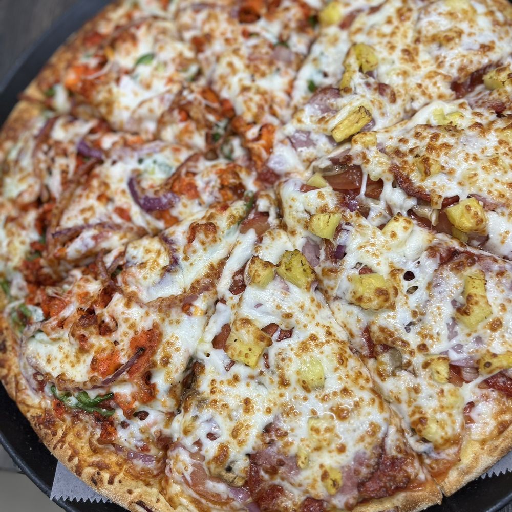 Promise Pizza - a pizza in a pan on a table - Pizza Near Me - Round Rock, Texas Promise Pizza - a pizza in a pan on a table - Pizza Near Me - Round Rock, Texas