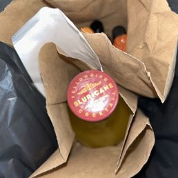 a bottle in a brown paper bag