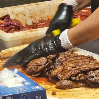 La Fiesta - a person cutting meat on a cutting board - Tacos Near Me - Buckeye, Arizona La Fiesta - a person cutting meat on a cutting board - Tacos Near Me - Buckeye, Arizona