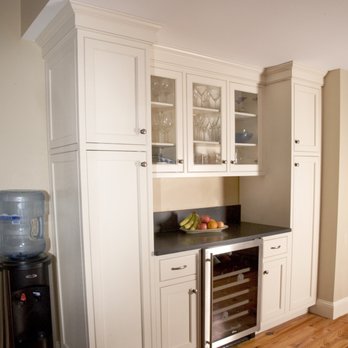 Dennis Kitchens - a kitchen with white cabinets and a black countertop - Cabinetry Near Me - Marshfield, Massachusetts Dennis Kitchens - a kitchen with white cabinets and a black countertop - Cabinetry Near Me - Marshfield, Massachusetts
