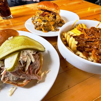 Slows Bar BQ - The Yardbird (top middle), pulled pork Waffle Fries W/ Hoffmans Cheddar (right), The Reason Sandwich (left). - Barbeque Near Me - Detroit, Michigan Slows Bar BQ - The Yardbird (top middle), pulled pork Waffle Fries W/ Hoffmans Cheddar (right), The Reason Sandwich (left). - Barbeque Near Me - Detroit, Michigan