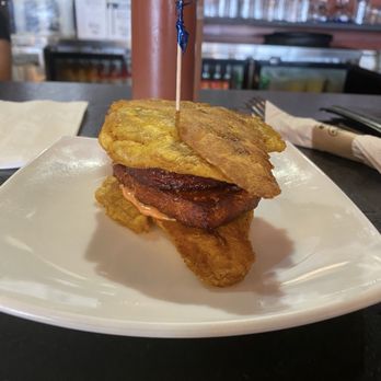 Chimiking Restaurant - Bacon and cheese biscuit on plantain buns. Well don't dish, I just don't like plantains. Admittedly it was soft, but just not for my taste. - Latin American Near Me - Orlando, Florida