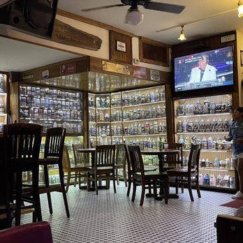 Rick's Bar - a man standing in front of a television - Bars Near Me - Key West, Florida