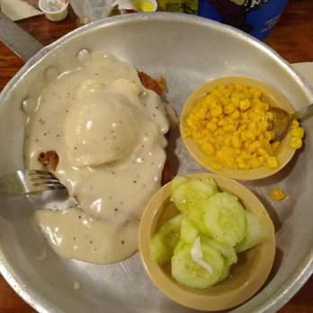 Lambert's Cafe - Ozark - Chicken fried steak served in an aluminum skillet with mashed potatoes, cream gravy, corn, and cucumbers with onions. - American Near Me - Ozark, Missouri Lambert's Cafe - Ozark - Chicken fried steak served in an aluminum skillet with mashed potatoes, cream gravy, corn, and cucumbers with onions. - American Near Me - Ozark, Missouri