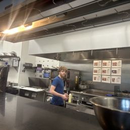 Employee fixing your food. It's state law that all hair is covered including beards. Employee fixing your food. It's state law that all hair is covered including beards.