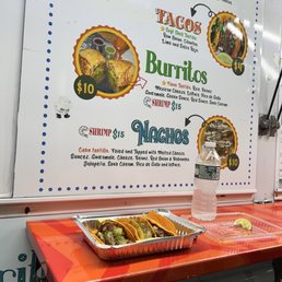 a taco stand with a variety of burritos