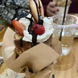 Little House of Pastries - Chimney Cake...an airy pastry filled with fruit, drizzled with chocolate and topped with whipped cream and a cookie.