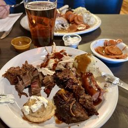 Sharing is caring. Beef brisket burnt ends, chopped smoked beef brisket, double smoked bratwurst & pulled smoked chicken w/ fixins