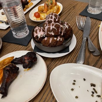 18th & 21st - Donut of the day (skip it - more like burnt sweet hush puppies), smoked wings, and shrimp and grits in the background. - Cocktail Bars Near Me - Columbia, Maryland 18th & 21st - Donut of the day (skip it - more like burnt sweet hush puppies), smoked wings, and shrimp and grits in the background. - Cocktail Bars Near Me - Columbia, Maryland