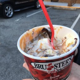 a person holding a cup of ice cream a person holding a cup of ice cream