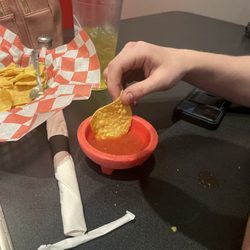 Casa Fiesta - A chip about to lose it life battle in a bowl of fresh dipping salsa