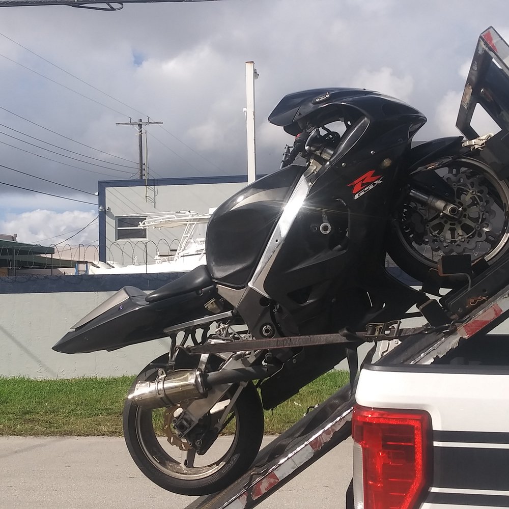 Moto Tow - Front wheel chocked and secured, then the bike is tied with ratchet straps. - Towing Near Me Moto Tow - Front wheel chocked and secured, then the bike is tied with ratchet straps. - Towing Near Me