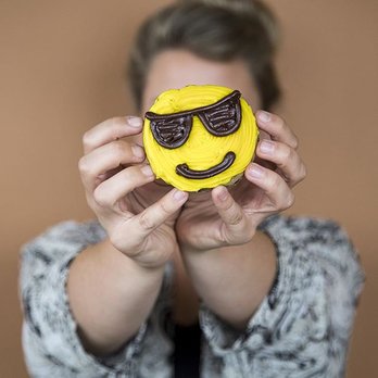 Great American Cookies - a woman holding a smiley face cupcake - Bakeries Near Me - Cedar Hill, Texas Great American Cookies - a woman holding a smiley face cupcake - Bakeries Near Me - Cedar Hill, Texas