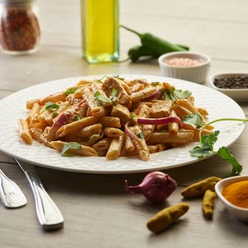 Pizza Twist - a plate of pasta with meat and vegetables - Pizza Near Me - Burien, Washington