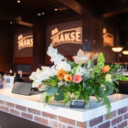 Stems Florist - Beautiful floral display by Stems Floral at Mäksē Restaurant, adding a warm welcome for our guests