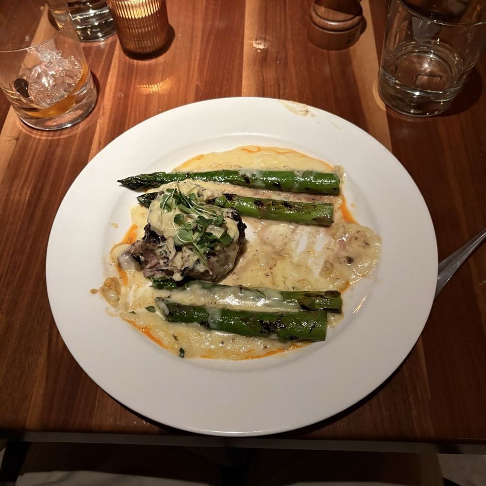 Oscar filet mignon with crab meat and hollandaise over potatoes and asparagus. Oscar filet mignon with crab meat and hollandaise over potatoes and asparagus.