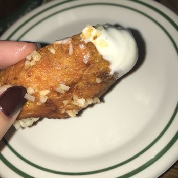 Flanigan's - Pinecrest - Close up of a delicious buffalo wing with garlic! - American Near Me - Miami, Florida