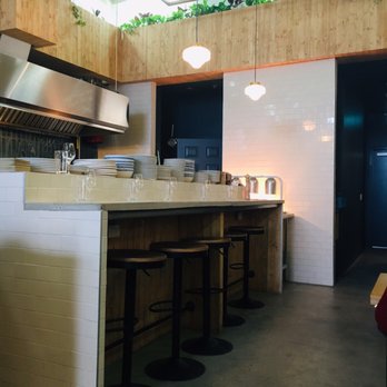 Magnolia - a kitchen with a counter and stools - French Near Me - Montreal, Quebec Magnolia - a kitchen with a counter and stools - French Near Me - Montreal, Quebec