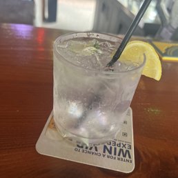 a drink with a lemon wedge a drink with a lemon wedge