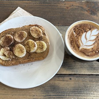 Still Waters Coffeehouse - Almond Butter Banana toast and a Flat White coffee. - Coffee & Tea Near Me - Gray, Tennessee Still Waters Coffeehouse - Almond Butter Banana toast and a Flat White coffee. - Coffee & Tea Near Me - Gray, Tennessee