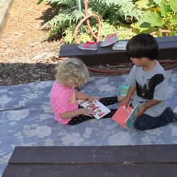 Tender Care Eco-Friendly Pre-school & Child Care - Reading at the Community Garden.