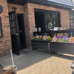 Exterior outside entrance of Leo's Midway - Outside bar near flowers - Garden City, New York Exterior outside entrance of Leo's Midway - Outside bar near flowers - Garden City, New York