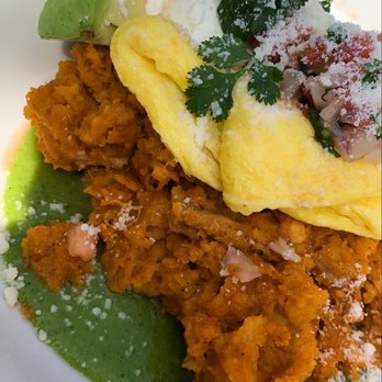 Murphy's - Chilaquiles. Chicken and tortillas, over medium eggs, tomatillo sauce, avocado, sour cream - American Near Me - Atlanta, Georgia