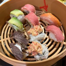 Japanese box (8 bite for 2 pack) 2/10  Don't think salmon supposed to be brown red arrow for reference  Fish taste warm, rice is hard