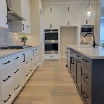 Drop Point Construction - a kitchen with white cabinets and stainless steel appliances - General Contractors Near Me Drop Point Construction - a kitchen with white cabinets and stainless steel appliances - General Contractors Near Me
