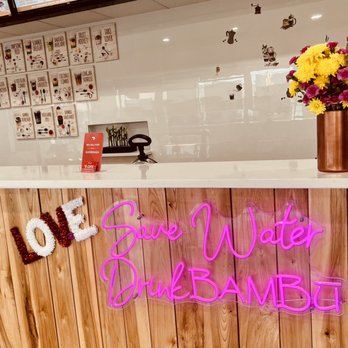 BAMBU - a bar with a neon sign and flowers - Bubble Tea Near Me - Syracuse, New York