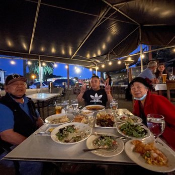 Sailor Jack's - a group of people sitting at a table with plates of food - Seafood Near Me - Benicia, California