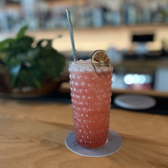 Room Service - a pink drink with a straw and a lemon garnish - Cocktail Bars Near Me - Charlotte, North Carolina Room Service - a pink drink with a straw and a lemon garnish - Cocktail Bars Near Me - Charlotte, North Carolina