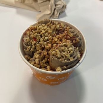 Curly Cream Rolled Ice Cream - Vegan chocolate, banana mix in, topped with chopped nuts and strawberry syrup - Ice Cream & Frozen Yogurt Near Me - Destin, Florida Curly Cream Rolled Ice Cream - Vegan chocolate, banana mix in, topped with chopped nuts and strawberry syrup - Ice Cream & Frozen Yogurt Near Me - Destin, Florida