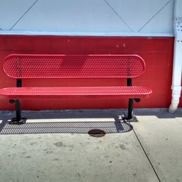 two red benches on a sidewalk