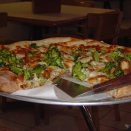 a pizza with broccoli a pizza with broccoli