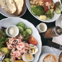 The shrimp salad and prosciutto salads on a table on the street.