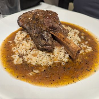 Osteria - Lamb shank over risotto with a red wine reduction sauce.(Special) - Italian Near Me - Greensboro, North Carolina Osteria - Lamb shank over risotto with a red wine reduction sauce.(Special) - Italian Near Me - Greensboro, North Carolina