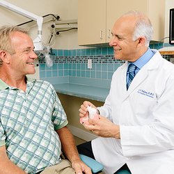 Sheldon & Furtado - Dr. Lee Sheldon showing a patient how dental implants work.