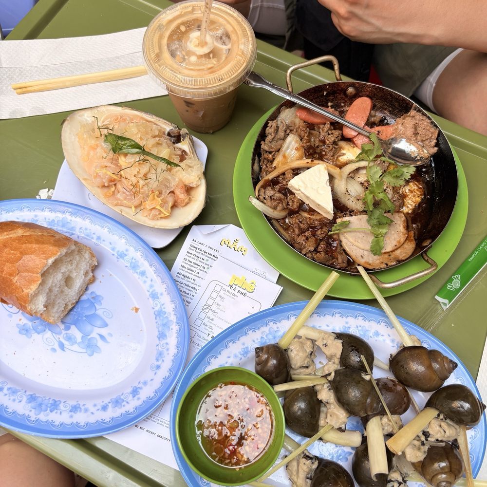 Phe - Clockwise: Stuffed Snail, bread for Banh Mi, Raw Surf Clam Salad, Fish Caramel Latte, and Banh Mi - Vietnamese Near Me - New York, New York Phe - Clockwise: Stuffed Snail, bread for Banh Mi, Raw Surf Clam Salad, Fish Caramel Latte, and Banh Mi - Vietnamese Near Me - New York, New York