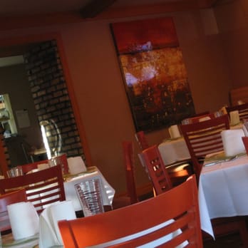 Francks - tables, chairs, settings, wall art, and entrance to servers' area. - New American Near Me - Holladay, Utah