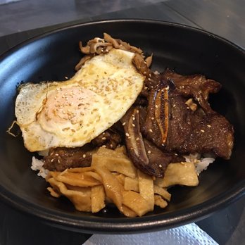 Burning Rice - Fried egg W fishcake & Kalbi short ribs. Many sauces a sweet barbecue sauce or some spicy  sauce.  I put a little of both. - Korean Near Me - Dallas, Texas
