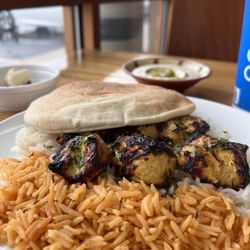 Taste of Jerusalem - Chicken Kabob on fire!!! White and spicy rice with a pita also the Hummus rich creamy fresh and full of flavor!! Bam!