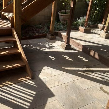 Green Landscape Construction - a wooden staircase leading up to a deck - Landscaping Near Me