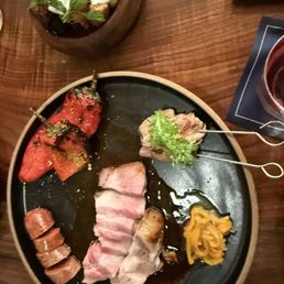 Pork served family style- pork multiple ways, cooked on the woodfire.