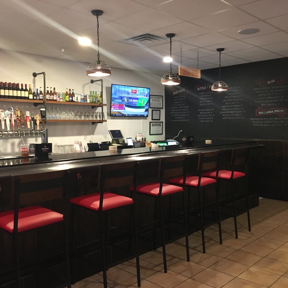 a bar with red bar stools
