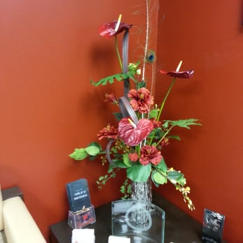 Florals-N-Foliage - Silk Tropical Arrangement. Red Anthurium and Gerbera daises, Peacock feathers plus various foliages - Floral Designers Near Me Florals-N-Foliage - Silk Tropical Arrangement. Red Anthurium and Gerbera daises, Peacock feathers plus various foliages - Floral Designers Near Me