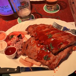 Succulent pork ribs with chips and some sauce on the side