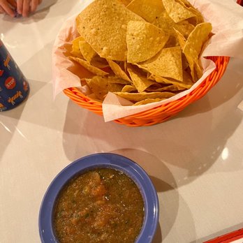 La Mision - Chips and salsa - A basket filled with tortilla chips lined with paper, placed on a table, with a bowl of salsa nearby. - Mexican Near Me - Midland, Texas