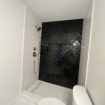 Tile Worx & Beyond - Walk-in shower with a glamorous herringbone subway tile - Tiling Near Me